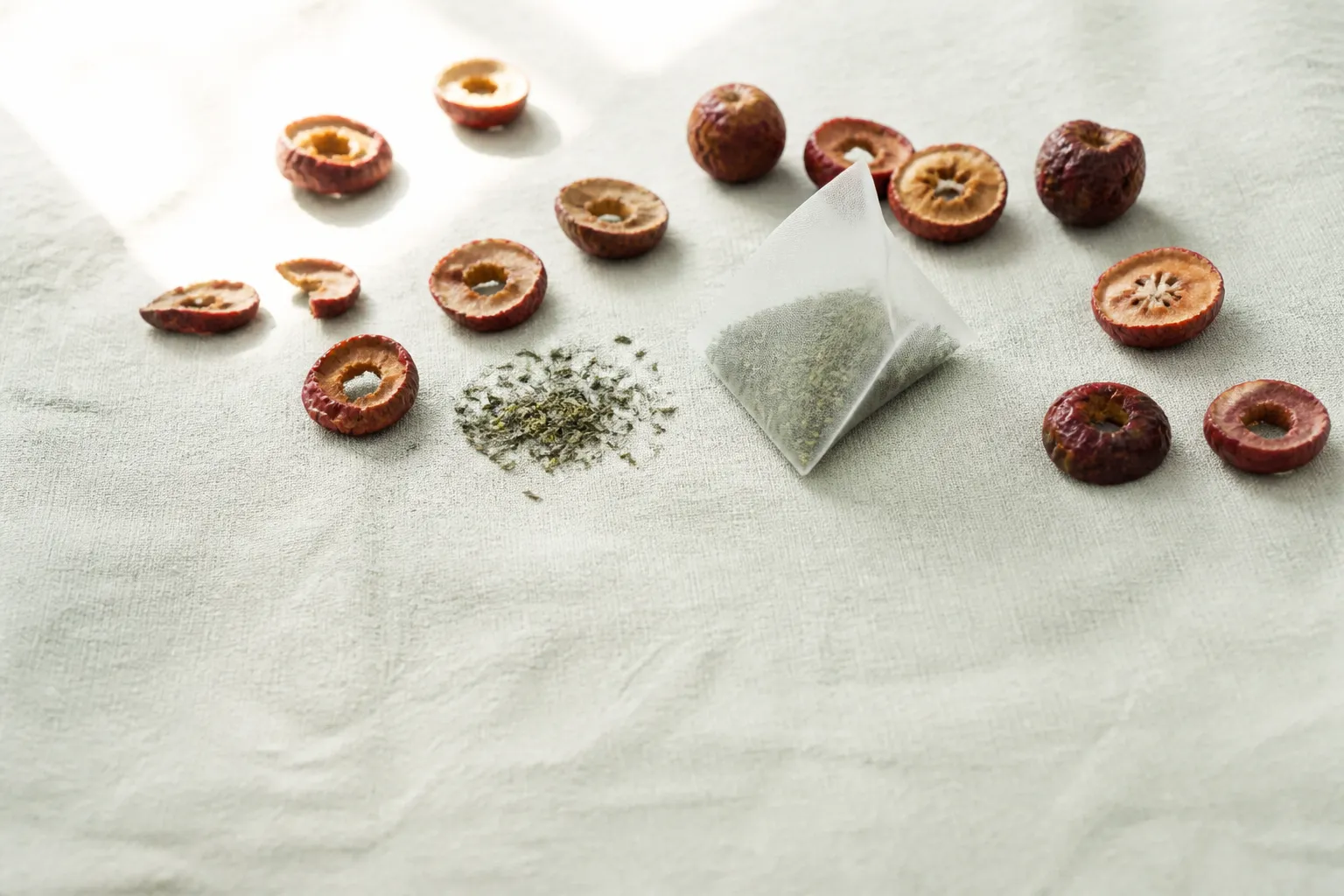 Dried hawthorn slices and a green tea bag for hawthorn green tea