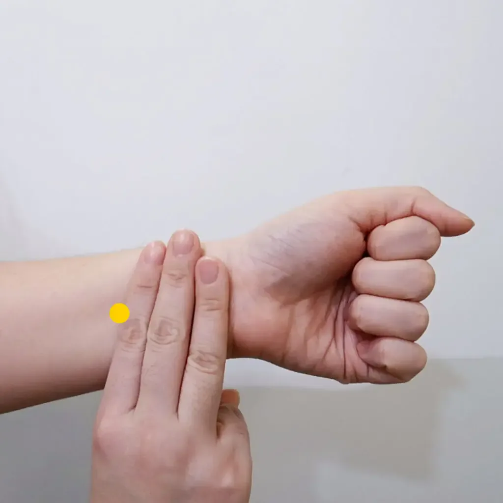 Three fingers on the inner forearm locating Nei Guan PC6 between two tendons