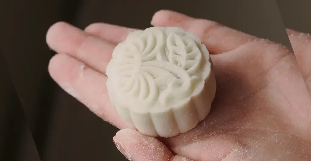 Snowskin mooncake in a hand for the Mid-Autumn soft-skin calorie myth