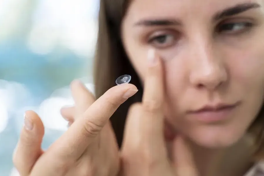 Contact lens on a fingertip, a common stye hygiene trigger