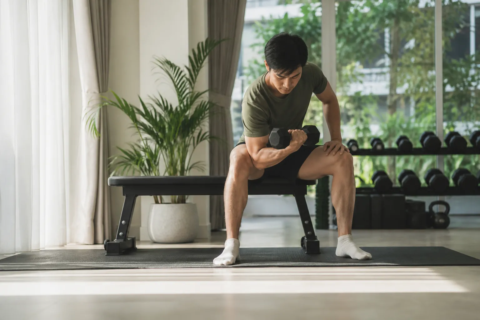 Person lifting a dumbbell during an afternoon strength workout