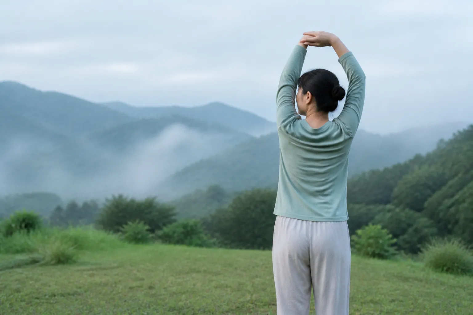 Person stretching at dawn before a morning workout outdoors