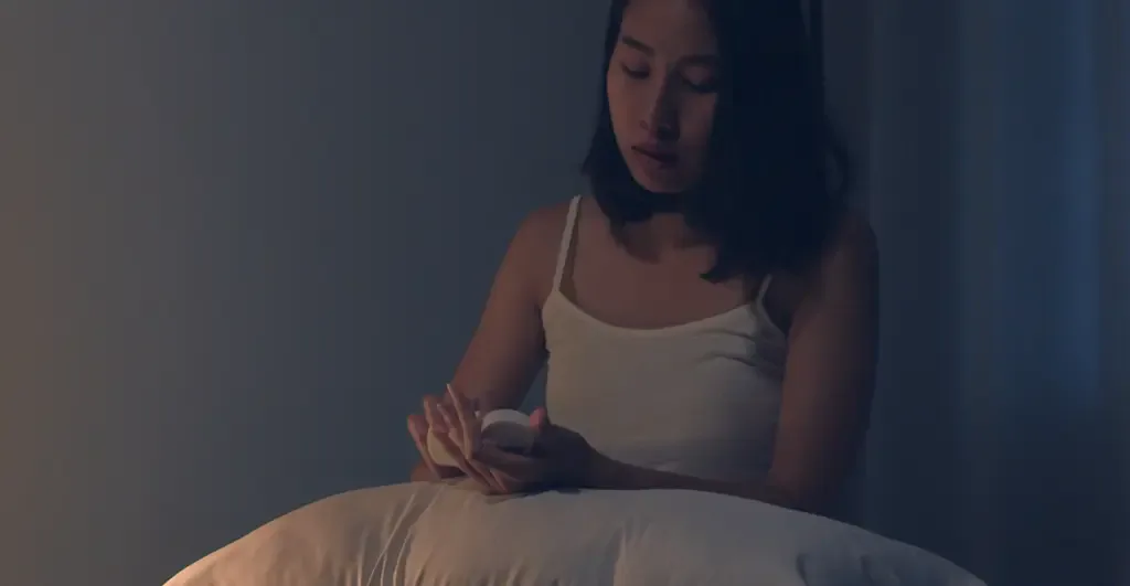Person resting in bed at night, seeking calm sleep