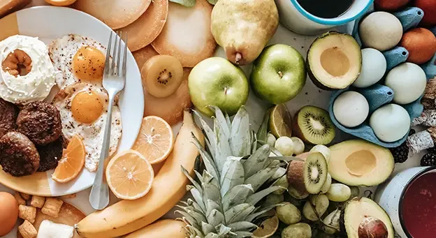 Breakfast fruit spread with citrus, kiwi, avocado, and whole fruit for dietary fibre