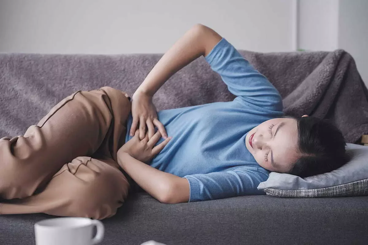 Woman holding the pelvis through period cramps