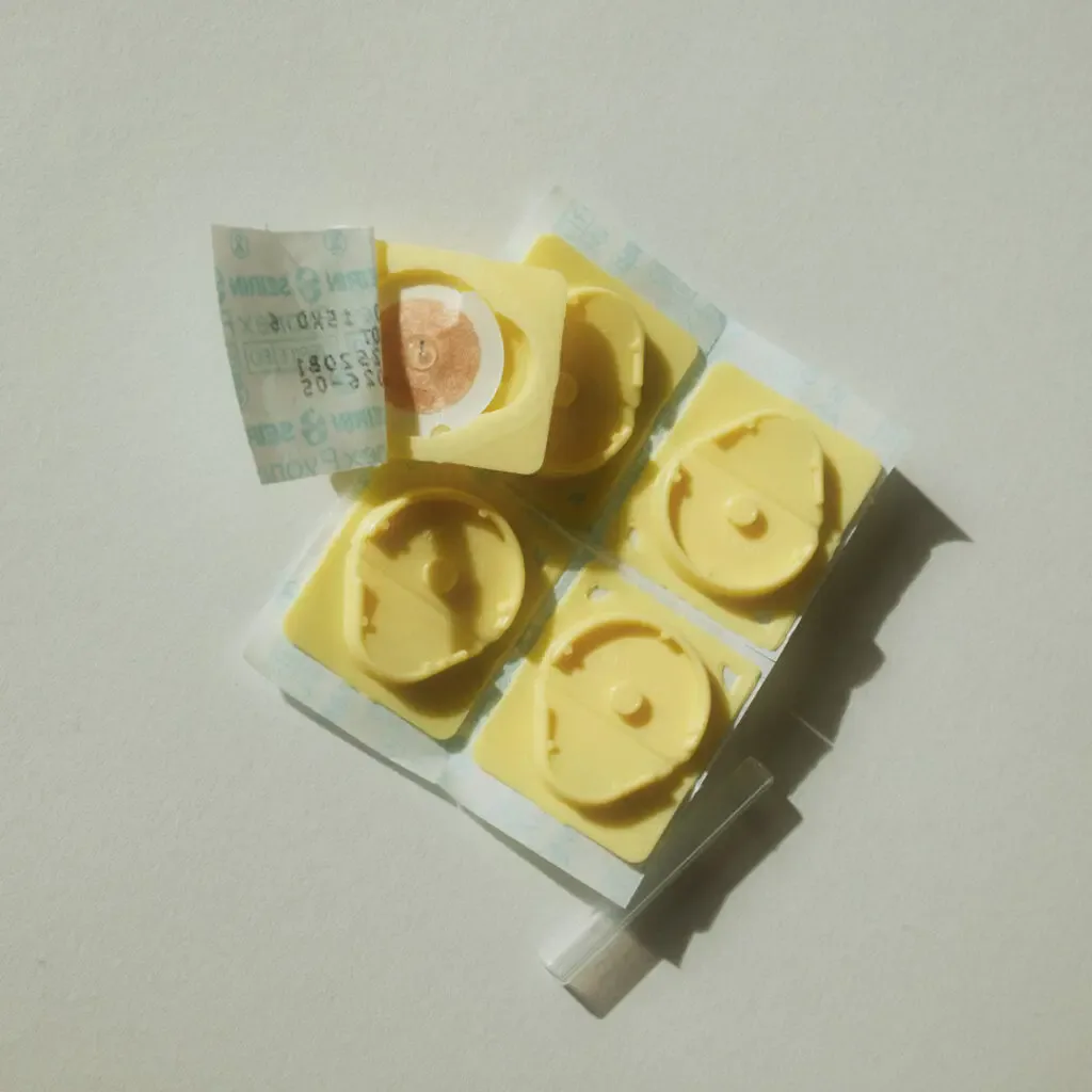 Open Seirin Pyonex press-needle tray showing adhesive patches and applicator tube