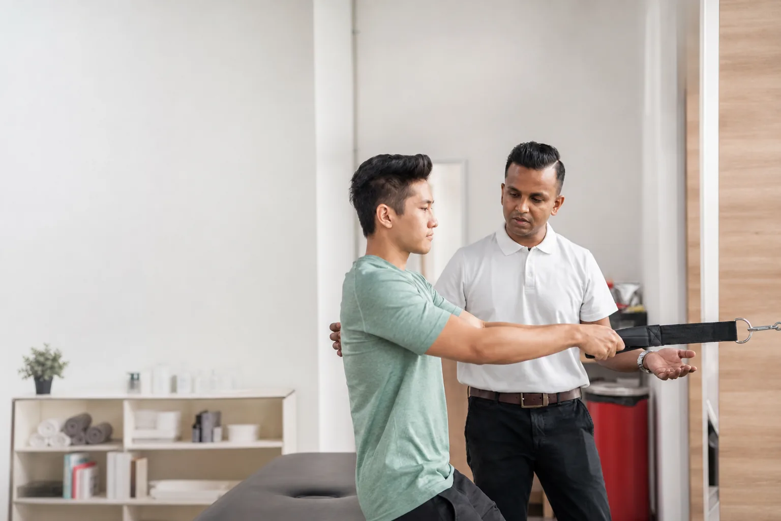 Physiotherapist guiding standing resistance exercise during recovery care at Woodleigh