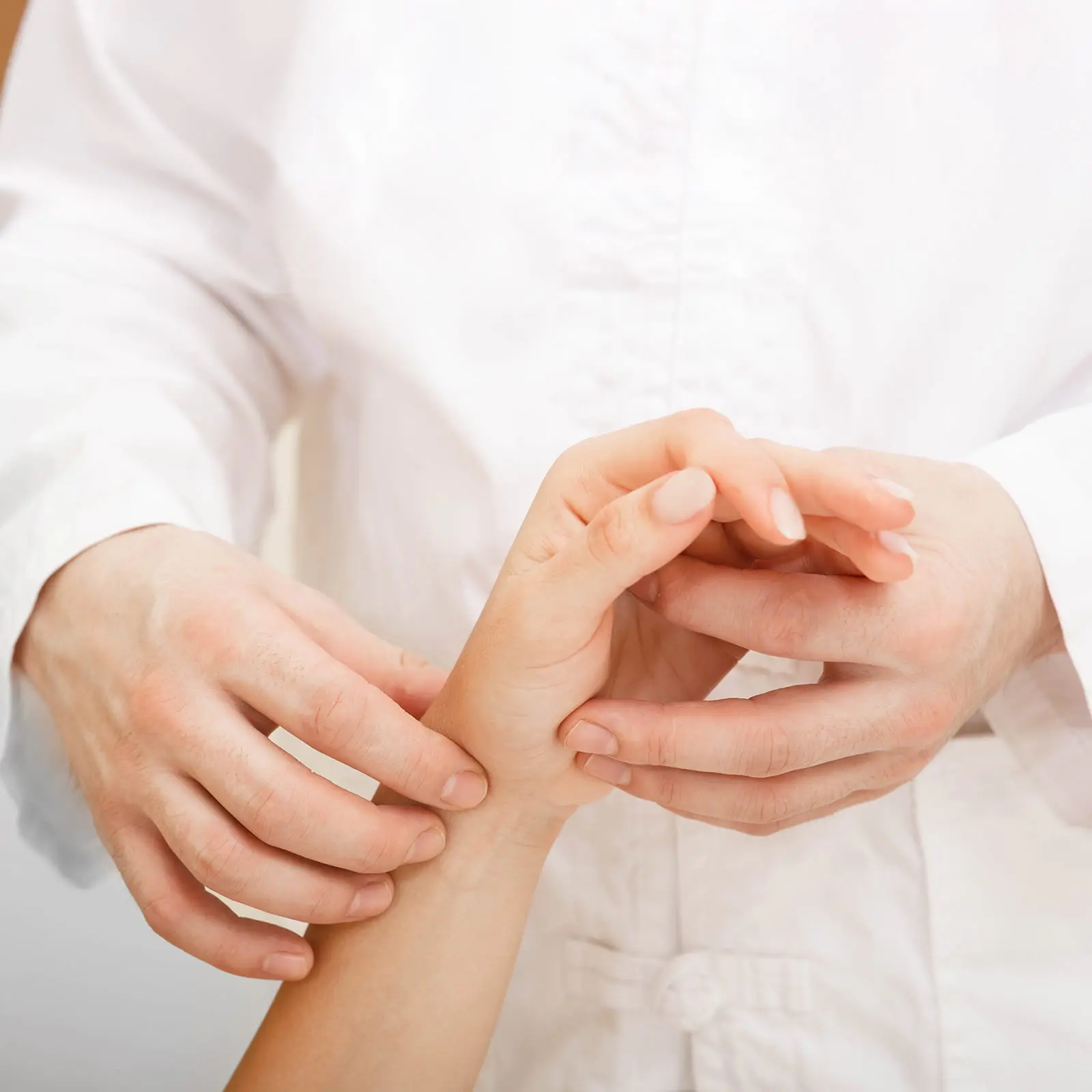 TCM physician performing a precise pulse diagnosis at PULSE Signature