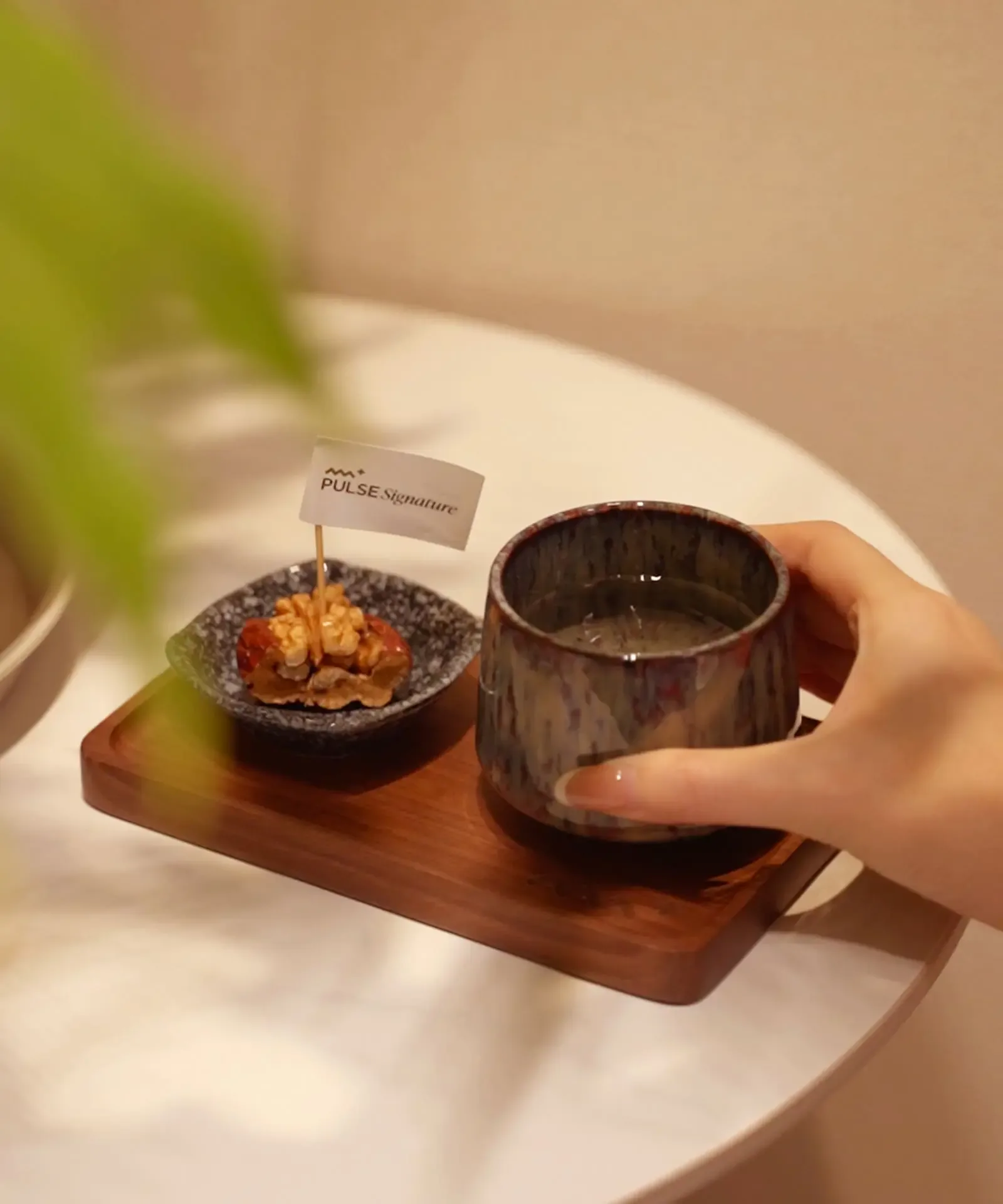 Welcome hospitality tray with tea and stone bowl at PULSE Signature